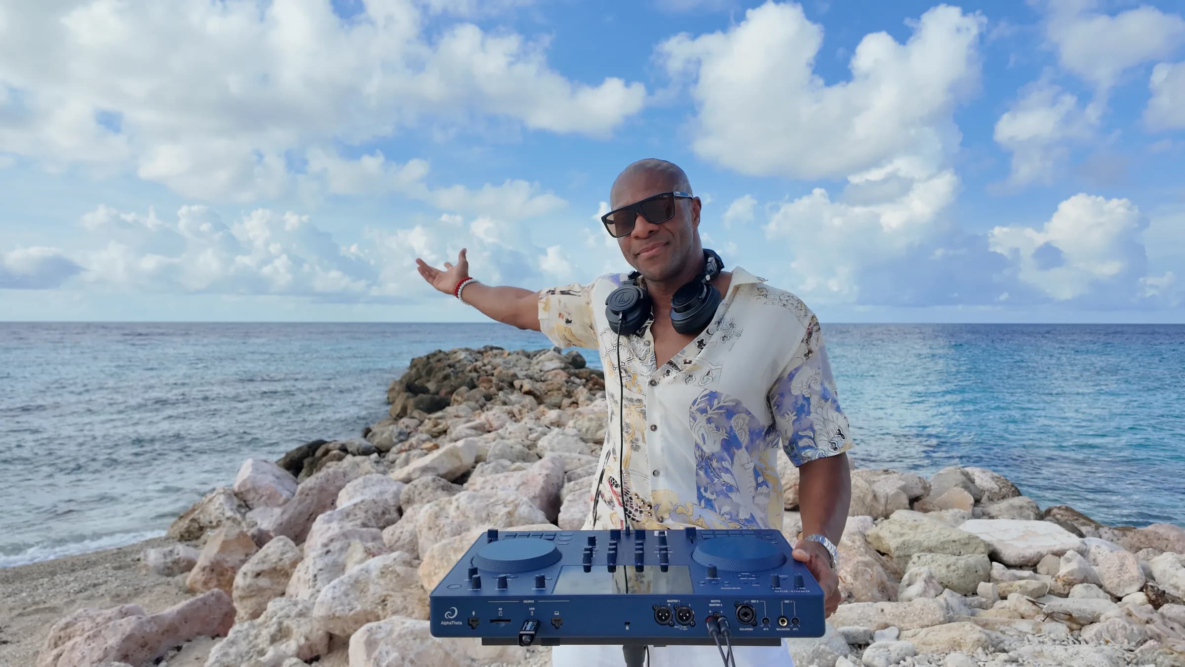 DJ NEXYS performing at an open-air shoreline set